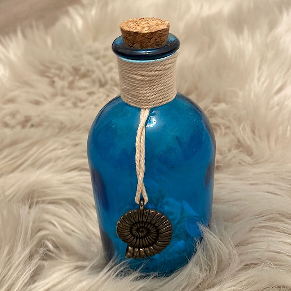 A bottle with sea shells and Crystal’s